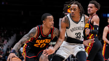 Dec 10, 2021; Atlanta, Georgia, USA; Atlanta Hawks forward John Collins (20) is defended by Brooklyn Nets forward Nic Claxton (33) during the second half at State Farm Arena. Mandatory Credit: Dale Zanine-USA TODAY Sports