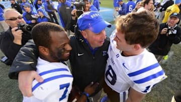 Nov 30, 2013; Chapel Hill, NC, USA; Duke Blue Devils quarterbacks Anthony Boone (7) and Brandon Connette (18) with quarterbacks coach Kurt Roper after the game. The Blue Devils defeated the North Carolina Tar Heels 27-25 at Kenan Memorial Stadium. Mandatory Credit: Bob Donnan-USA TODAY Sports