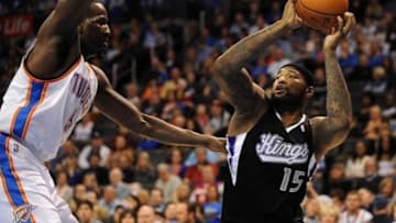Jan 19, 2014; Oklahoma City, OK, USA; Sacramento Kings center DeMarcus Cousins (15) holds the ball as Oklahoma City Thunder center Kendrick Perkins (5) defends during the second quarter at Chesapeake Energy Arena. Mandatory Credit: Mark D. Smith-USA TODAY Sports