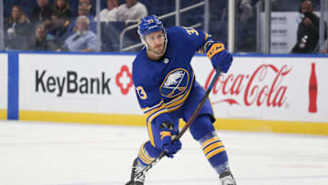 BUFFALO, NEW YORK - OCTOBER 16: Colin Miller #33 of the Buffalo Sabres attempts a shot during the second period of a NHL hockey game against the Arizona Coyotes at KeyBank Center on October 16, 2021 in Buffalo, New York. (Photo by Joshua Bessex/Getty Images)
