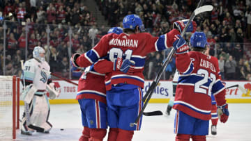 Dec 4, 2023; Montreal, Quebec, CAN; Montreal Canadiens forward Sean Monahan (91) celebrates with teammates including forward Cole Caufield (22) and forward Nick Suzuki (14) after scoring a goal against Seattle Kraken goalie Philipp Grubauer (31) during the second period at the Bell Centre. Mandatory Credit: Eric Bolte-USA TODAY Sports