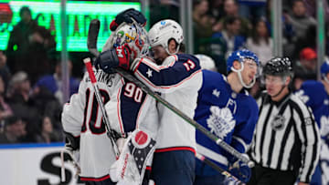 Feb 11, 2023; Toronto, Ontario, CAN; Columbus Blue Jackets defenseman Andrew Peeke (2) and goaltender Elvis Merzlikins (90) celebrate a win over the Toronto Maple Leafs during the third period at Scotiabank Arena. Mandatory Credit: John E. Sokolowski-USA TODAY Sports