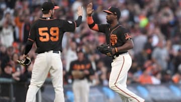SAN FRANCISCO, CA - JUNE 02: Andrew McCutchen #22 of the San Francisco Giants gets a high-five from starting pitcher Andrew Suarez #59 after McCutchen ran down a deep fly ball in right center field for the third out of the top of the third inning against the Philadelphia Phillies at AT&T Park on June 2, 2018 in San Francisco, California. (Photo by Thearon W. Henderson/Getty Images)