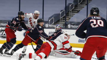 Feb 8, 2021; Columbus, Ohio, USA; Carolina Hurricanes left wing Brock McGinn (23) falls to the ice as he scores a goal against the Columbus Blue Jackets during the second period at Nationwide Arena. Mandatory Credit: Russell LaBounty-USA TODAY Sports