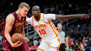 Oct 6, 2021; Atlanta, Georgia, USA; Cleveland Cavaliers forward Lauri Markkanen (24) controls the ball against Atlanta Hawks center Gorgui Dieng (10) during the first half at State Farm Arena. Mandatory Credit: Dale Zanine-USA TODAY Sports
