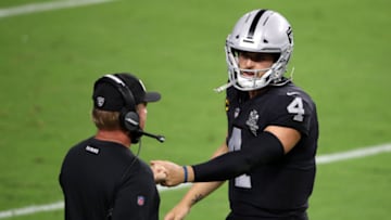 LAS VEGAS, NEVADA - SEPTEMBER 21: Derek Carr #4 of the Las Vegas Raiders talks with head coach Jon Gruden on the sidelines against the New Orleans Saints at Allegiant Stadium on September 21, 2020 in Las Vegas, Nevada. (Photo by Christian Petersen/Getty Images)
