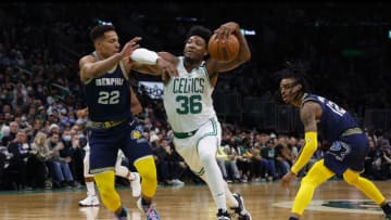 Mar 3, 2022; Boston, Massachusetts, USA; Boston Celtics guard Marcus Smart (36) drives between Memphis Grizzlies guard Desmond Bane (22) and guard Ja Morant (12) during the first quarter at TD Garden. Mandatory Credit: Winslow Townson-USA TODAY Sports