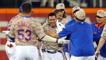 Jul 7, 2014; New York, NY, USA; New York Mets shortstop Ruben Tejada (11) is congratulated by teammates after his game-winning RBI single against the Atlanta Braves during the eleventh inning of a game at Citi Field. The Mets defeated the Braves 4-3 in eleven innings. Mandatory Credit: Brad Penner-USA TODAY Sports
