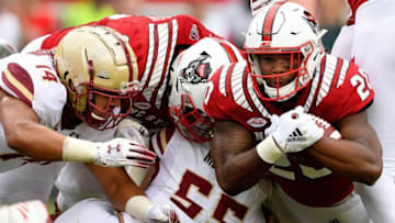 RALEIGH, NC - OCTOBER 06: Isaiah McDuffie #55 of the Boston College Eagles tackles Ricky Person Jr. #20 of the North Carolina State Wolfpack during their game at Carter-Finley Stadium on October 6, 2018 in Raleigh, North Carolina. (Photo by Grant Halverson/Getty Images)