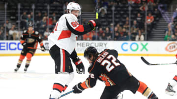 ANAHEIM, CALIFORNIA - MARCH 10: Ron Hainsey #81 of the Ottawa Senators battles Sonny Milano #22 of the Anaheim Ducks for a loose puck during the first period of a game at Honda Center on March 10, 2020 in Anaheim, California. (Photo by Sean M. Haffey/Getty Images)