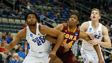 PITTSBURGH, PA - MARCH 15: Marques Bolden #20 and Jack White #41 of the Duke Blue Devils defend against Tyrell Williams #44 of the Iona Gaels during the game in the first round of the 2018 NCAA Men's Basketball Tournament at PPG PAINTS Arena on March 15, 2018 in Pittsburgh, Pennsylvania. (Photo by Justin K. Aller/Getty Images)