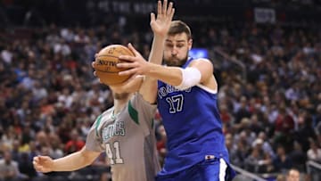 Jan 10, 2017; Toronto, Ontario, CAN; Toronto Raptors center Jonas Valanciunas (17) grabs a rebound in front of Boston Celtics forward Kelly Olynyk (41) at Air Canada Centre. The Raptors won 114-106. Mandatory Credit: Tom Szczerbowski-USA TODAY Sports