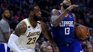 LOS ANGELES, CALIFORNIA - MARCH 08: Paul George #13 of the LA Clippers reacts from a push from LeBron James #23 of the Los Angeles Lakers during a 112-103 Lakers win at Staples Center on March 08, 2020 in Los Angeles, California. NOTE TO USER: User expressly acknowledges and agrees that, by downloading and or using this photograph, User is consenting to the terms and conditions of the Getty Images License Agreement. (Photo by Harry How/Getty Images)