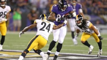 Sep 11, 2014; Baltimore, MD, USA; Baltimore Ravens wide receiver Steve Smith (89) tries to avoid a tackle by Pittsburgh Steelers cornerback Ike Taylor (24) at M&T Bank Stadium. Mandatory Credit: Mitch Stringer-USA TODAY Sports