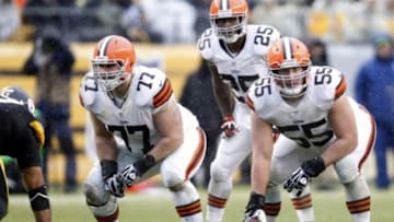 Dec 29, 2013; Pittsburgh, PA, USA; Cleveland Browns guard John Greco (77) and running back Chris Ogbonnaya (25) and center Alex Mack (55) at the line of scrimmage against the Pittsburgh Steelers during the second quarter at Heinz Field. The Steelers won 20-7. Mandatory Credit: Charles LeClaire-USA TODAY Sports