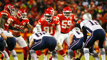 KANSAS CITY, MO - JANUARY 20: Nose tackle Derrick Nnadi #91 of the Kansas City Chiefs, with teammates inside linebacker Anthony Hitchens #53 of the Kansas City Chiefs and inside linebacker Reggie Ragland #59 of the Kansas City Chiefs, adjust positions before a New England Patriots fourth down run at Arrowhead Stadium on January 20, 2019 in Kansas City, Missouri. (Photo by David Eulitt/Getty Images)