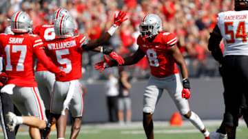 Oct 9, 2021; Columbus, Ohio, USA; Ohio State Buckeyes defensive end Javontae Jean-Baptiste (8)with the sack and forced fumble of Maryland Terrapins quarterback Taulia Tagovailoa (3)during the first half at Ohio Stadium. Mandatory Credit: Joseph Maiorana-USA TODAY Sports