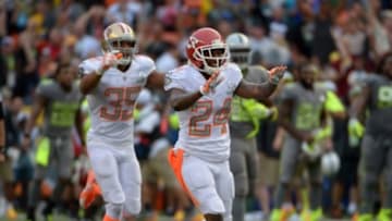 January 26, 2014; Honolulu, HI, USA; Team Rice cornerback Brandon Flowers of the Kansas City Chiefs (24) and safety Eric Reid of the San Francisco 49ers (35) celebrate at the end of the 2014 Pro Bowl at Aloha Stadium. Team Rice defeated Team Sanders 22-21. Mandatory Credit: Kirby Lee-USA TODAY Sports