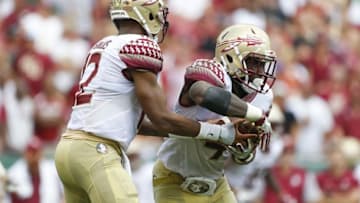 Sep 24, 2016; Tampa, FL, USA; Florida State Seminoles quarterback Deondre Francois (12) hands the ball off to running back Dalvin Cook (4) in the second half against the South Florida Bulls at Raymond James Stadium. Florida State Seminoles won 55-35. Mandatory Credit: Logan Bowles-USA TODAY Sports