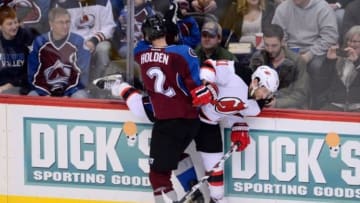 Jan 14, 2016; Denver, CO, USA; Colorado Avalanche defenseman Nick Holden (2) checks New Jersey Devils right wing Stephen Gionta (11) in the second period at the Pepsi Center. Mandatory Credit: Ron Chenoy-USA TODAY Sports