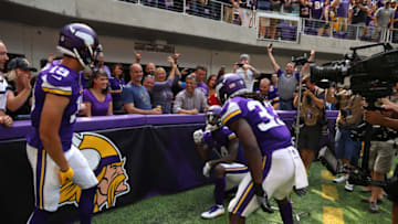 MINNEAPOLIS, MN - SEPTEMBER 24: Stefon Diggs #14 of the Minnesota Vikings celebrates a touchdown on the sidelines with teammates Adam Thielen #19 and Dalvin Cook #33 in the second quarter of the game agains the Tampa Bay Buccaneers on September 24, 2017 at U.S. Bank Stadium in Minneapolis, Minnesota. (Photo by Adam Bettcher/Getty Images)