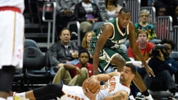 Feb 20, 2016; Atlanta, GA, USA; Atlanta Hawks forward Thabo Sefolosha (25) grabs a loose ball on the floor in front of Milwaukee Bucks guard Khris Middleton (22) during the first half at Philips Arena. Mandatory Credit: Dale Zanine-USA TODAY Sports