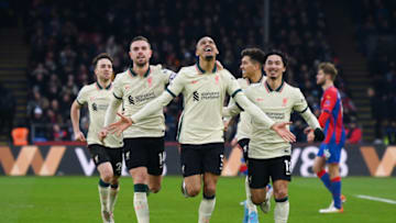 LONDON, ENGLAND - JANUARY 23: Fabinho of Liverpool celebrates with teammates Jordan Henderson and Takumi Minamino (R) after scoring their side's third goal from the penalty spot during the Premier League match between Crystal Palace and Liverpool at Selhurst Park on January 23, 2022 in London, England. (Photo by Mike Hewitt/Getty Images)