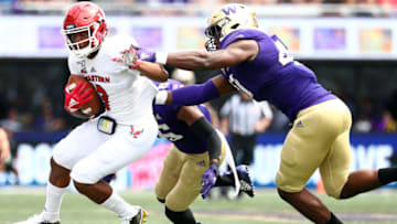 SEATTLE, WASHINGTON - AUGUST 31: Eric Barriere #3 of the Eastern Washington Eagles is tackled against Myles Rice #41 of the Washington Huskies in the third quarter during their game at Husky Stadium on August 31, 2019 in Seattle, Washington. (Photo by Abbie Parr/Getty Images)