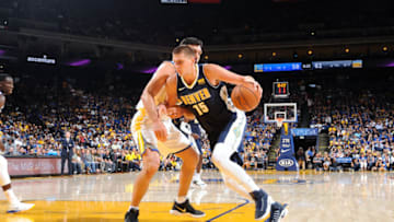 OAKLAND, CA - SEPTEMBER 30: Nikola Jokic #15 of the Denver Nuggets drives to the basket during the game against the Golden State Warriors during a preseason game on September 30, 2017 at ORACLE Arena in Oakland, California. NOTE TO USER: User expressly acknowledges and agrees that, by downloading and or using this photograph, user is consenting to the terms and conditions of Getty Images License Agreement. Mandatory Copyright Notice: Copyright 2017 NBAE (Photo by Noah Graham/NBAE via Getty Images)