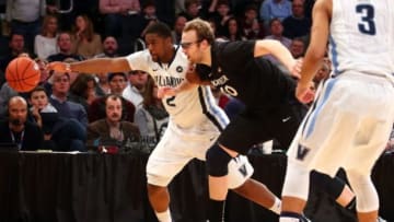 Mar 14, 2015; New York, NY, USA; Villanova Wildcats forward Kris Jenkins (2) and Xavier Musketeers center Matt Stainbrook (40) chase the ball during the first half of the Big East Tournament championship game at Madison Square Garden. Mandatory Credit: Brad Penner-USA TODAY Sports