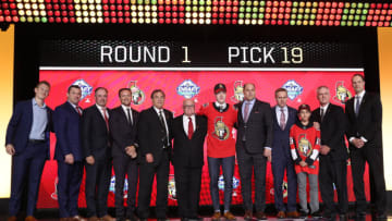 VANCOUVER, BRITISH COLUMBIA - JUNE 21: Lassi Thomson (sixth from right), nineteenth overall pick of the Ottawa Senators, poses for a group photo with team personnel during the first round of the 2019 NHL Draft at Rogers Arena on June 21, 2019 in Vancouver, Canada. (Photo by Dave Sandford/NHLI via Getty Images)