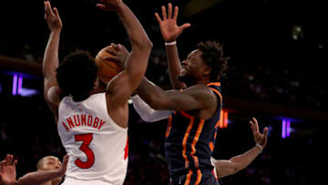 NEW YORK, NEW YORK - JANUARY 16: Julius Randle #30 of the New York Knicks heads for the net as O.G. Anunoby #3 of the Toronto Raptors defends during the second half at Madison Square Garden on January 16, 2023 in New York City. The Toronto Raptors defeated the New York Knicks 123-121 in overtime. NOTE TO USER: User expressly acknowledges and agrees that, by downloading and or using this photograph, User is consenting to the terms and conditions of the Getty Images License Agreement. (Photo by Elsa/Getty Images)