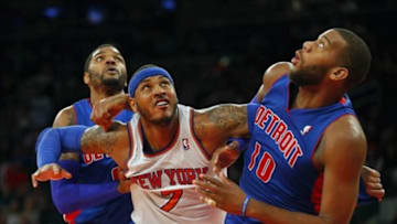 Jan 7, 2014; New York, NY, USA; New York Knicks small forward Carmelo Anthony (7) battles Detroit Pistons power forward Greg Monroe (10) and small forward Josh Smith (6) for rebound in closing seconds of game at Madison Square Garden. New York Knicks defeat the Detroit Pistons 89-85. Mandatory Credit: Jim O