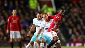 MANCHESTER, ENGLAND - NOVEMBER 27: Mark Noble of West Ham United (C) and Paul Pogba of Manchester United (R) battle for possession during the Premier League match between Manchester United and West Ham United at Old Trafford on November 27, 2016 in Manchester, England. (Photo by Alex Livesey/Getty Images)