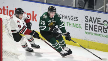 LONDON, ON - FEBRUARY 13: Billy Moskal #76 of the London Knights skates around the net with the puck as Nick Suzuki #9 of the Guelph Storm defends in the second period during OHL game action at Budweiser Gardens on February 13, 2019 in London, Canada. (Photo by Tom Szczerbowski/Getty Images)