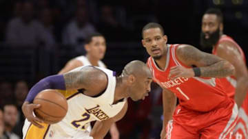 Jan 17, 2016; Los Angeles, CA, USA; Los Angeles Lakers forward Kobe Bryant (24) drives against Houston Rockets forward Trevor Ariza (1) during the NBA basketball game at Staples Center. Mandatory Credit: Richard Mackson-USA TODAY Sports