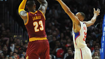 March 13, 2016; Los Angeles, CA, USA; Cleveland Cavaliers forward LeBron James (23) shoots a basket against Los Angeles Clippers forward Wesley Johnson (33) during the second half at Staples Center. Mandatory Credit: Gary A. Vasquez-USA TODAY Sports