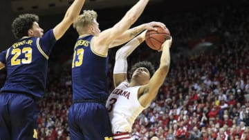 BLOOMINGTON, INDIANA - JANUARY 25: Brandon Johns Jr #23 and Ignas Brazdeikis #13 of the Michigan Wolverines defend the shot of Justin Smith #3 of the Indiana Hoosiers at Assembly Hall on January 25, 2019 in Bloomington, Indiana. (Photo by Andy Lyons/Getty Images)