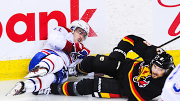CALGARY, AB - MARCH 11: Christopher Tanev #8 of the Calgary Flames collies with Brendan Gallagher #11 of the Montreal Canadiens during an NHL game at Scotiabank Saddledome on March 11, 2021 in Calgary, Alberta, Canada. (Photo by Derek Leung/Getty Images)