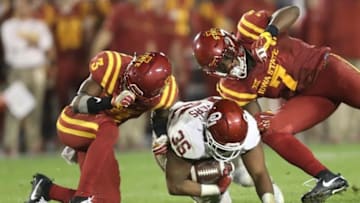 Nov 3, 2016; Ames, IA, USA; Oklahoma Sooners fullback Dimitri Flowers (36) slides between Iowa State Cyclones tacklers defensive back Mike Johnson (3) and Iowa State Cyclones linebacker Willie Harvey (7) at Jack Trice Stadium. Oklahoma beat Iowa State 34 to 24. Mandatory Credit: Reese Strickland-USA TODAY Sports
