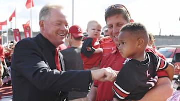 Sep 1, 2016; Louisville, KY, USA; Louisville Cardinals head coach Bobby Petrino (L) talks to fans during the Card March prior to the game against the Charlotte 49ers at Papa John