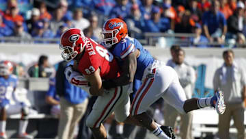 Nov 1, 2014; Jacksonville, FL, USA; Georgia Bulldogs tight end Jeb Blazevich (83) catches the ball as Florida Gators linebacker Antonio Morrison (3) defends during the first quarter at EverBank Field. Mandatory Credit: Kim Klement-USA TODAY Sports