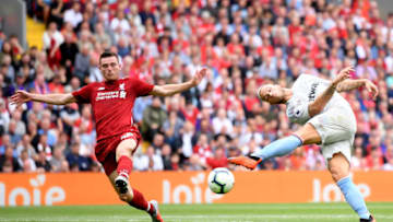 LIVERPOOL, ENGLAND - AUGUST 12: Marko Arnautovic of West Ham United misses a shot under pressure from Andy Robertson of Liverpool during the Premier League match between Liverpool FC and West Ham United at Anfield on August 12, 2018 in Liverpool, United Kingdom. (Photo by Laurence Griffiths/Getty Images)