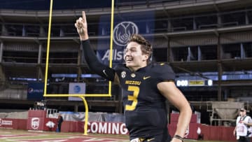 FAYETTEVILLE, AR - NOVEMBER 24: Drew Lock #3 of the Missouri Tigers runs around the field in celebration after a game against the Arkansas Razorbacks at Razorback Stadium on November 24, 2017 in Fayetteville, Arkansas. The Tigers defeated the Razorbacks 48-45. (Photo by Wesley Hitt/Getty Images)