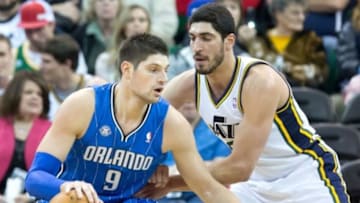 Mar 22, 2014; Salt Lake City, UT, USA; Utah Jazz center Enes Kanter (0) defends against Orlando Magic center Nikola Vucevic (9) during the second half at EnergySolutions Arena. The Jazz won 89-88. Mandatory Credit: Russ Isabella-USA TODAY Sports