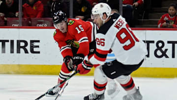 Apr 1, 2023; Chicago, Illinois, USA; Chicago Blackhawks right wing Joey Anderson (15) and New Jersey Devils right wing Timo Meier (96) fight for the puck during the first period at the United Center. Mandatory Credit: Matt Marton-USA TODAY Sports