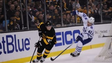 Jan 16, 2016; Boston, MA, USA; Boston Bruins defenseman Torey Krug (47) skates with the puck while Toronto Maple Leafs center Tyler Bozak (42) gives chase during the first period at TD Garden. Mandatory Credit: Bob DeChiara-USA TODAY Sports