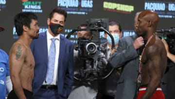 LAS VEGAS, NEVADA - AUGUST 20: Manny Pacquiao (L), President of Manny Pacquiao Promotions Sean Gibbons (2nd L) and WBA welterweight champion Yordenis Ugas (R) stand onstage during an official weigh-in at MGM Grand Garden Arena on August 20, 2021 in Las Vegas, Nevada. Pacquiao will challenge Ugas for his title at T-Mobile on August 21 in Las Vegas. (Photo by Ethan Miller/Getty Images)