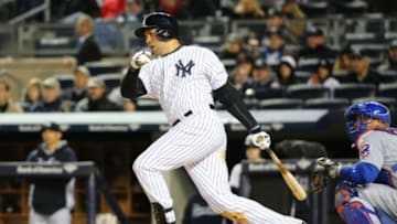 Apr 16, 2014; Bronx, NY, USA; New York Yankees right fielder Carlos Beltran (36) singles to left advancing a man during the third inning against the Chicago Cubs at Yankee Stadium. Mandatory Credit: Anthony Gruppuso-USA TODAY Sports