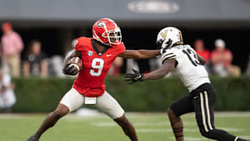 ATHENS, GA - OCTOBER 15: Jackson Meeks #9 of the Georgia Bulldogs stiff arms CJ Taylor #13 of the Vanderbilt Commodores at Sanford Stadium on October 15, 2022 in Athens, Georgia. (Photo by Adam Hagy/Getty Images)